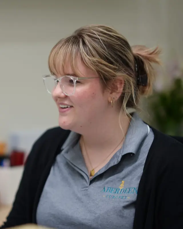A receptionist at the Aberdeen Surgery front desk