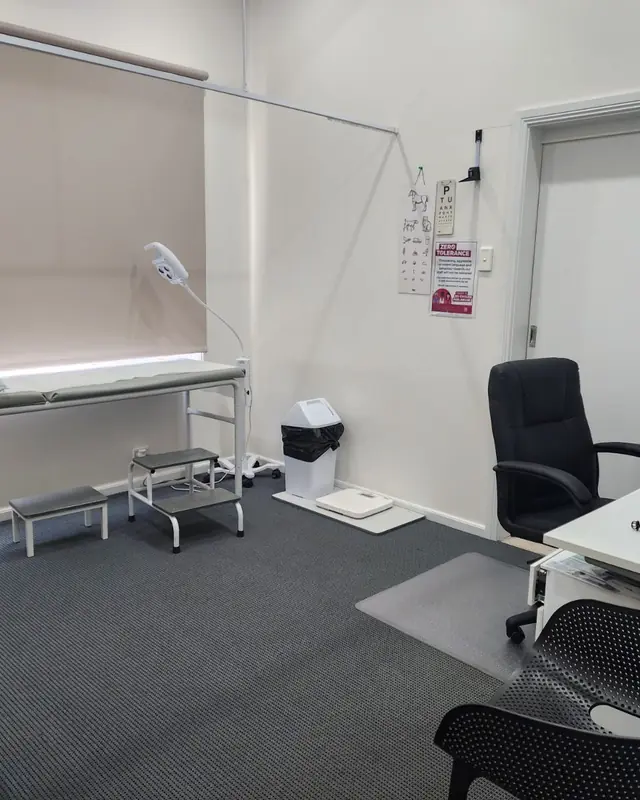 A consult room at Aberdeen Surgery with an examination bed, steps and a GP desk